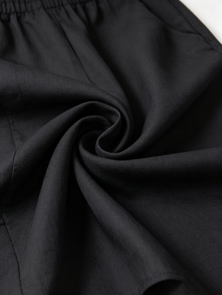 Sveva | Tuta nera off-shoulder dalla linea morbida