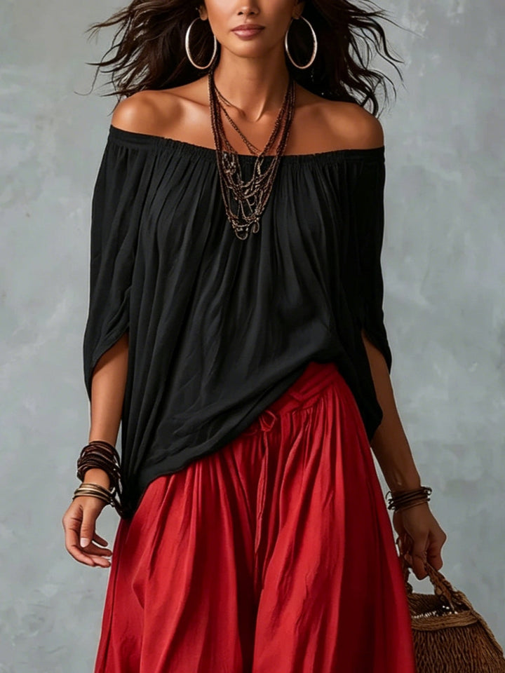 Carmela | Completo due pezzi con top nero off-shoulder e pantaloni lanterna rossi
