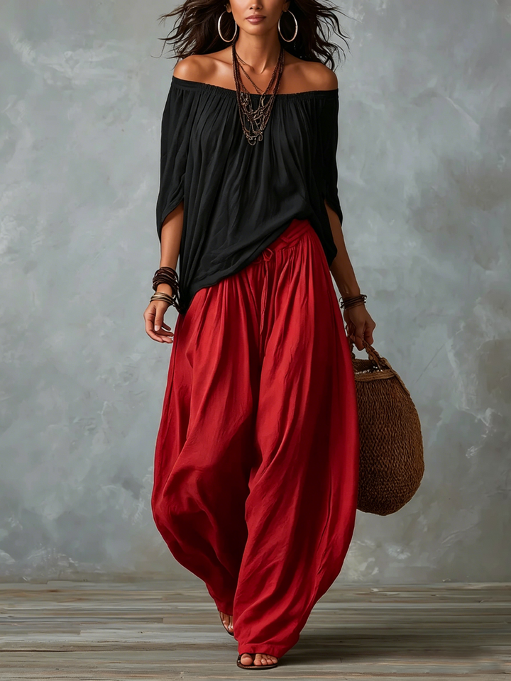 Carmela | Completo due pezzi con top nero off-shoulder e pantaloni lanterna rossi